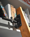 Built Tough Sliding Barn Door Track Kit With Rust Proof Extension Rail And Quiet Floor Roller For Quick Home Or Library Setup Smooth Glide Motion Reliable Structure Handles Three Hundred Thirty Pounds. Close-up of rail attachment to a wooden ladder.