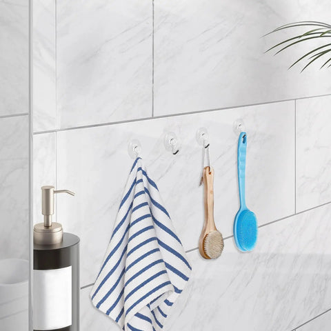 Forty Pack Mini Clear Suction Cup Hooks With Sleek Metal Utility Rings holding a towel and brushes in bathroom.
