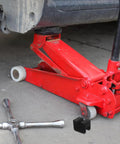 Red hydraulic car jack with Jack Pad Cover Kit For Car Jacks, Rubber Cushions Protect Pinch Welds And Frame Rails When Lifting visible
