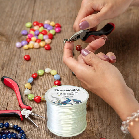 Flat 0.8 mm Elastic Bead Rope for Jewelry Making, Clear Polyester Spandex String with tools and beads on wooden table
