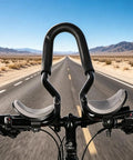 Clip On Aero Bar For Road Cycling Aluminum Alloy Armrest Bar With Soft Sponge Cushion on a bike on desert highway