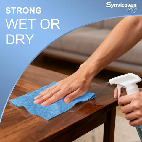 Person using Top Tier Heavy Duty Embossed Jumbo Roll Industrial Cleaning Wipes 10 By 15 Inches on wooden surface.