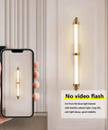 JGSYD Led Modern Wall Lamp Indoor with Remote Control Wall Light 2700K-6500K Dimmable Wall Sconce Long Strip Decorative Wall Lighting Stainless Steel for Bedroom Hallway Living Room,Black-70Cm shown on a wall with a smartphone.