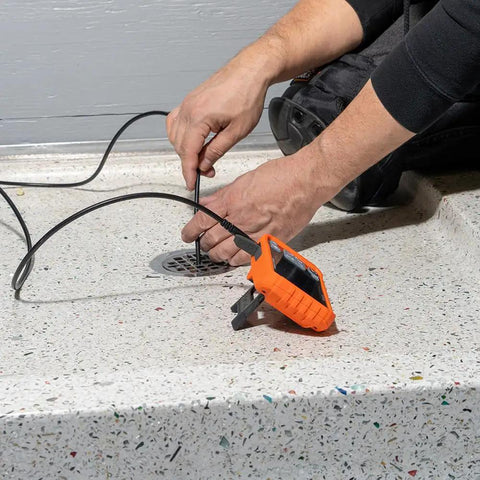 Hand using Replacement 5.5 mm 4.9 Foot Armored Waterproof Inspection Snake With LEDs For Plumbers Borescope Cat No ET18 in drain