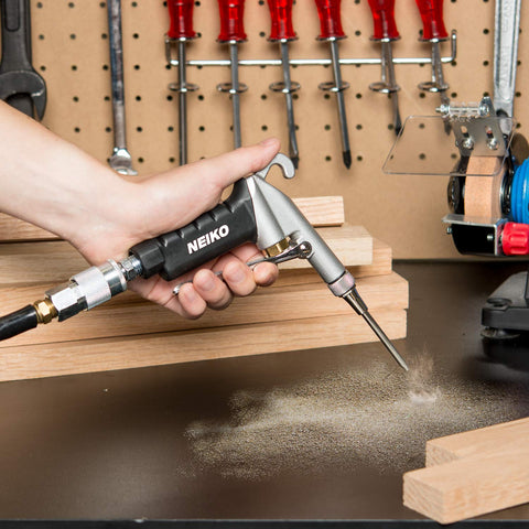 Person using High Flow Air Blow Gun With Three Piece Pneumatic Nozzle Kit For Dust Debris And Wet Spills, Pro Grade Shop Essential For Any Air Compressor, Quarter Inch Fittings, Easy Clean Up on workbench