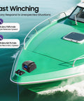 Top Notch 45 Lb Electric Anchor Winch For Boats With Remote Control on a green boat, showcasing fast winching capabilities.