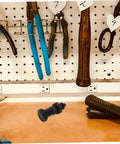 Heavy Duty Carbon Steel Reset Type Indexing Plunger on workbench with tools, used for industrial machinery and toolboxes.