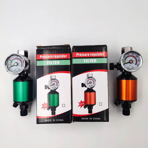 Green Pneumatic Spray Gun Pressure Regulator With Integrated Oil Water Separator And Paint Control Valve 1/4 Inch Thread next to orange variant.