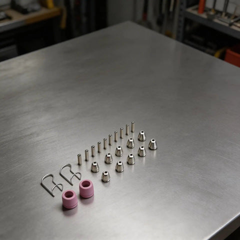 Top 24-Piece Plasma Cutter Consumables Kit For SG-55 with nozzles, electrodes, and shield rings on a metal surface.
