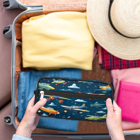 Hands holding Cartoon Airplane Makeup Bag Travel Toiletry Case For Women And Men Dopp Kit beside packed suitcase