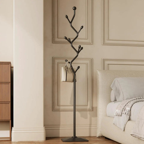 Tree Shaped Coat Rack With Eight Hooks Heavy Duty Freestanding Metal Coat Tree On Cast Iron Base in black, next to modern couch