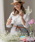Woman using Eight Piece Garden Shears Set In Four Color Variants for gardening, trimming flowers with bypass blade pruners.