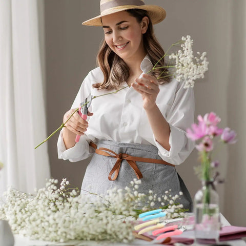 Woman using Eight Piece Garden Shears Set In Four Color Variants for gardening, trimming flowers with bypass blade pruners.