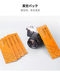 K&F Concept microfiber cleaning cloth packs, six orange packs beside a camera.