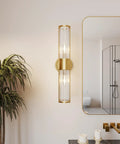 Gold Aluminum Wall Sconce With Cut Glass Shade, Up And Down Lighting beside bathroom mirror