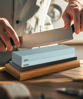 Using Go To Knife Sharpener Stone Set With Four Grit Waterstones 400 1000 3000 8000 Non Slip Bamboo Base on a kitchen knife.