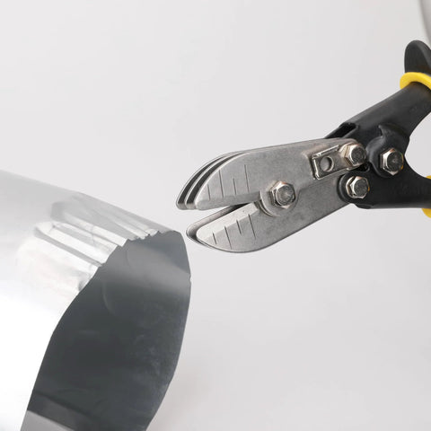 5-blade sheet metal crimper tool with black handle and yellow ring, close-up gripping ductwork