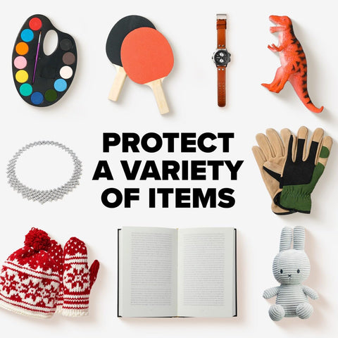 Various items including a watch, toys, gloves, and books illustrating the capacity of Large White Poly Bubble Mailer Size 5 10.5 X 15 In Inside Dimensions With Cushioned Bubble Liner, Durable And Flexible Exterior, 50 Percent Recycled Plastic, Ideal For Shipping Documents And Small Goods.