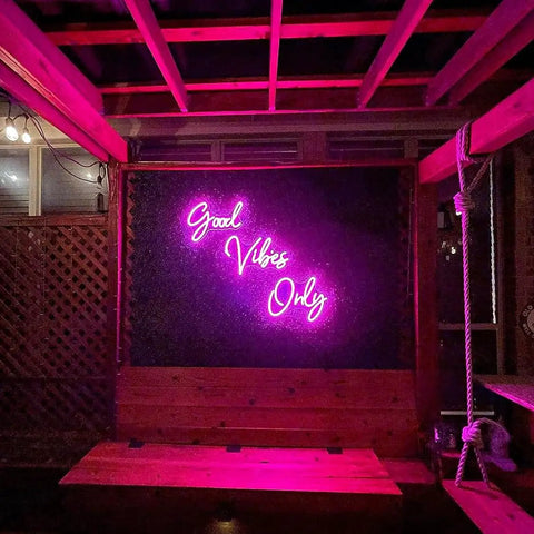 Pink Neon Sign With Dimmable LED Lights For Bedroom And Bar Decor Huge 56.57 Inch Wall Art That Sets Cozy Vibes For Home Parties Clubs And Nightlife Ambient Glow For Chill Vibes inside wooden room.