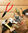 Beefy Heavy Duty Metal Sheet Bender Plier amidst various hand tools on a wooden surface, ideal for HVAC, automotive, jewelry, and DIY projects.