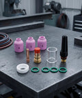 Heavy Duty Tig Torch Consumables Kit With Copper Collet Body And Clear Cup For Clean Welds, including ceramic nozzles and O-rings.