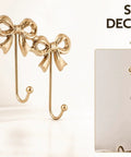Heavy Duty Gold Bow Knot Wall Hooks Dope Brass Triple Coat Hanger with elegant bows and hooks for easy organization.