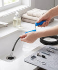 Heavy Duty Drain Auger Attachment For Kitchen Sink And Shower With 5 Meter Cable and flexible metal coil being used in a sink.