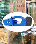 Heavy Duty Electric Strapping Machine With Automatic Tension, Welding And Cutting Functions For 9-16mm PP Pet Straps in warehouse setting.