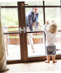 Stainless Steel Sliding Barn Door Lock And Latch Heavy Duty Rotating Hasp With Secure Gate Bolt on a wooden door with child and adult.