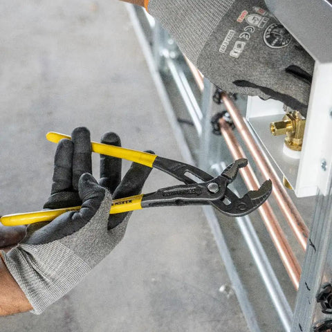 10 Inch Quick Adjust Tongue And Groove Pliers With Push Button Ratchet used in plumbing, showcasing narrow design for tight spaces.