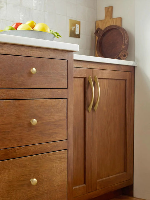 Brushed Gold Cabinet Knobs Round Brass Drawer Pulls installed on wooden kitchen cupboards, showcasing premium hardware for elegant finish.