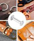 Badass Stainless Steel M4 Binding Posts And Flat Round Head Rivet Studs Barrel Screws shown with leather items and tools.