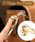 Premium Heavy Duty D Rings And Screws For Purses shiny gold D ring attached to purse, finger pressing the rotatable lock mechanism.