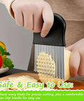 Large wavy crinkle cutter with stainless steel blade and black plastic handle slicing a potato