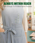 Slim 12 Inch Pocket Quilting Ruler In Clear Acrylic with green grid in a denim apron pocket in a sewing room.