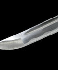 Close-up of Handmade Sharp Japanese Samurai Shirasaya Katana Sword blade tip, razor-sharp carbon steel, black background