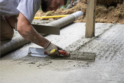 24 Inch Beveled End Magnesium Hand Float With DuraSoft Handle And Cast Magnesium Blade For Slick, Pro Level Concrete Finishes, Made In USA Mag Float For Wide Slabs And Commercial Pours used for smoothing concrete surface by worker.