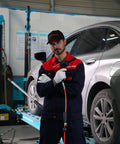 1/2 Inch Aluminum Air Impact Wrench Set Heavy Duty Beefy 1380 Ft Lbs Twin Hammer, mechanic holding tool in garage.