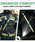 Firefighter wearing radio strap with reflective adjustable shoulder mic clip, visible in daylight and low-light conditions with flashlight.