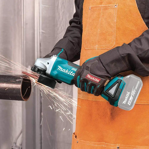 Person using 18V LXT Brushless Cordless Paddle Switch Cutoff And Angle Grinder Four And One Half Inch to cut metal pipe