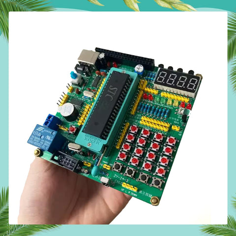 Hand-holding All In One MCU Starter Kit With 51 And 52 Demo Board, Soldering Practice Kit, and Learning Board with modules visible.