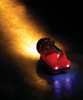 Orange Hand Held Rechargeable Lantern Flashlight With 150 Lumen Output, Up To 80,000 Peak Beam Candlepower shining on ground