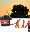 Heavy Duty RC Servo Motor Crushing Heavy Loads With Rock Solid High Torsion And Lightning Fast Response A Smooth Operator For Crawler Cars Robot Arms And Airplane Builds against a sunset silhouette background.