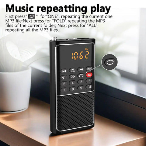 Pocket Mini FM Radio And MP3 Player with USB TF Card Support displaying FM tuning on a wooden desk.