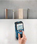 Nail Your Next Home Project Straight Up With This Hella Reliable Wall Scanner And Metal Detector featuring a user scanning a wall.
