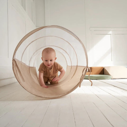 Toddler Tested Indoor Play Arena Featuring Super Soft Foam Climb Blocks Reconfigurable Crawl Tunnel used by a baby crawling inside.