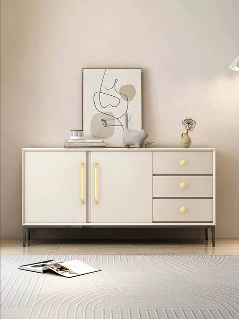Modern dresser with brushed gold cabinet knobs installed, artistic decor on top, showcasing 10 Pack Brushed Gold Round Cabinet Knobs 1-1/5 Inch 30mm Single Hole Drawer Pulls For Kitchen Cabinets And Drawers Easy Install Durable Hardware For Cabinets And Furniture Renovation.