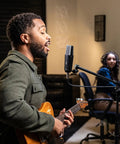 Musician recording with C104 Pro Large Diaphragm Cardioid Condenser Microphone For XLR Studio Use in a studio setting.