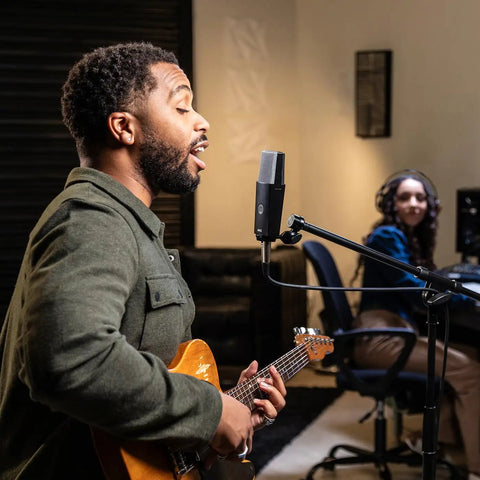 Musician recording with C104 Pro Large Diaphragm Cardioid Condenser Microphone For XLR Studio Use in a studio setting.