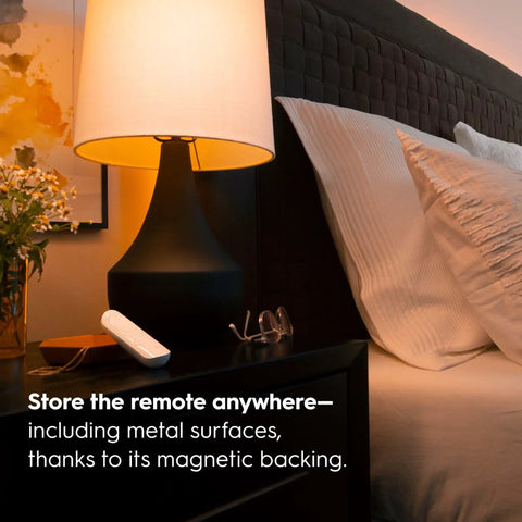 Cync Smart Remote Wire Free Battery Powered White Tones Control Bluetooth Remote on nightstand next to lamp and glasses